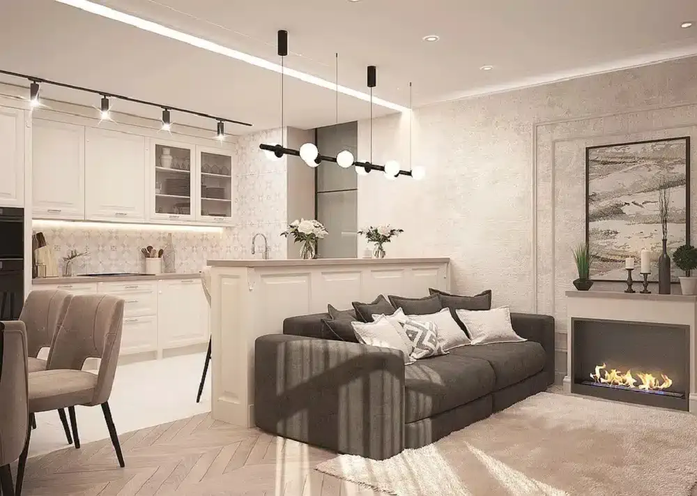 petite cuisine blanche lumineuse aménagée ouverte sur salon avec canapé gris